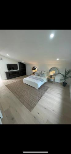 a bedroom with a bed with two lamps on it at 6 BEDROOM MODERN AND LUXURY HOME in Welland