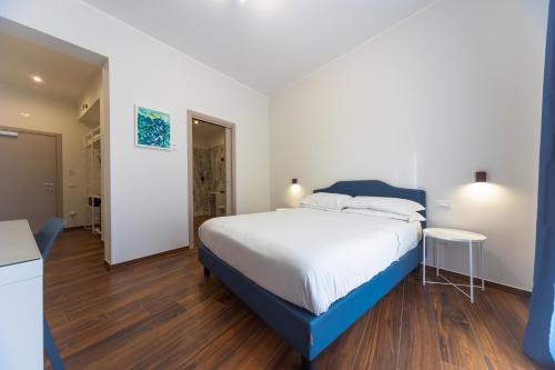 a bedroom with a large bed and wooden floors at SERENA PALACE SUPERIOR ROOMS in Mazara del Vallo