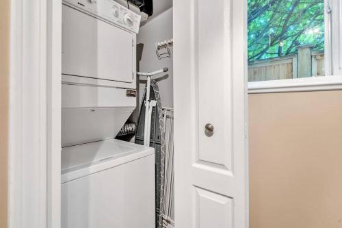 a kitchen with a white refrigerator next to a door at Luxury Retreat in Vancouver in Vancouver