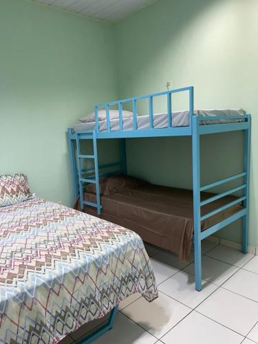 a bedroom with two bunk beds and a bed at Kitnet na cidade nova in Ananindeua