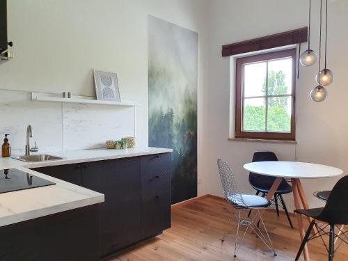 a kitchen with a table and chairs and a window at Gruberwirt Apartment mit Blick auf die Berge GW 7 in Innsbruck