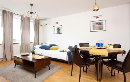 a living room with a bed and a dining room at Athenee Calea Victoriei Apartment in Bucharest