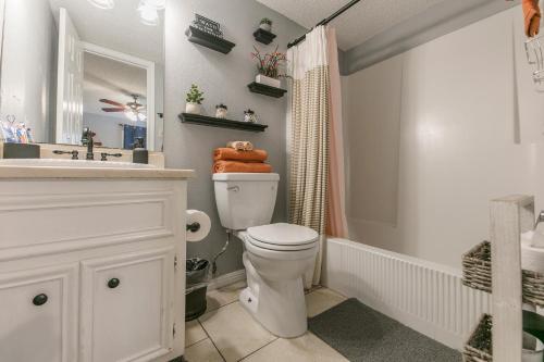 a bathroom with a white toilet and a sink at ★Modern,CozyCouple's Getaway w/Relaxing Patio! in Austin