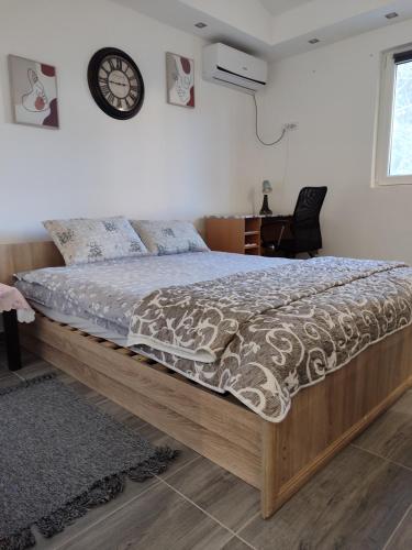 a bed with a wooden frame in a bedroom at Miljakovački konak in Belgrade
