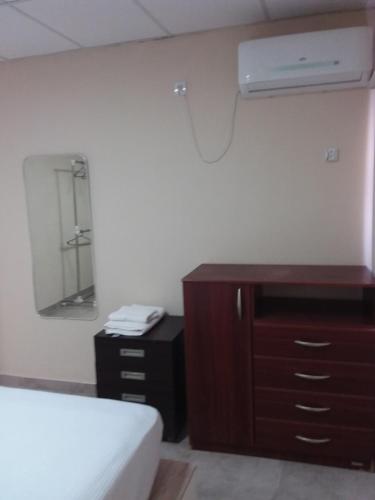 a bedroom with a bed and a dresser and a mirror at Lupita 3 in General Roca