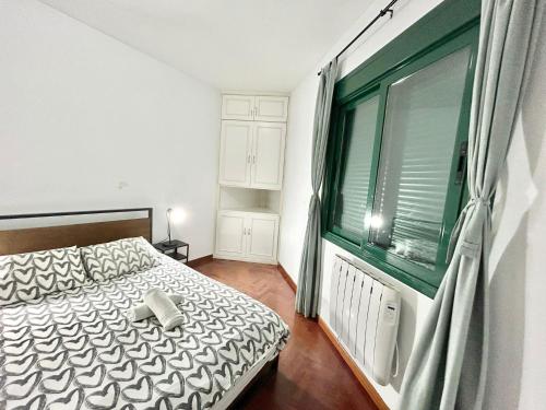 a bedroom with a bed and a large window at Centro Atocha Méndez Álvaro in Madrid