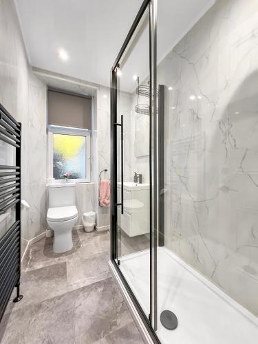 a bathroom with a shower and a toilet at No.3 The Villa in Oban