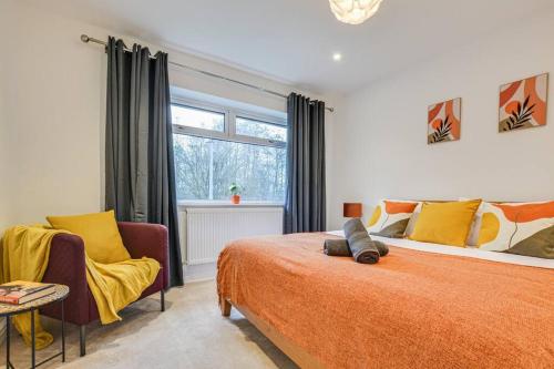 a bedroom with a bed and two chairs and a window at Calming and Serene 2 BR Getaway in Worsley