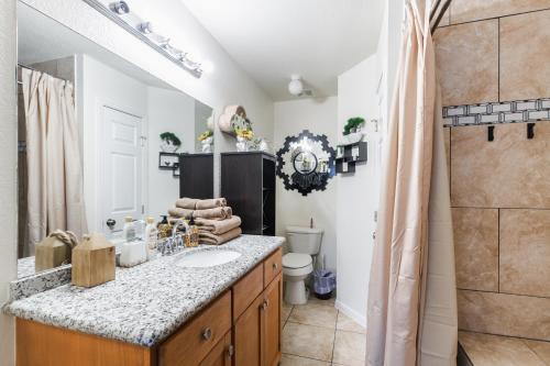 a bathroom with a sink and a toilet at Cozy 3BR Home Escape, Modern & Serene in Dickinson