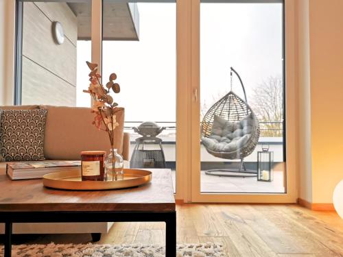 a living room with a couch and a coffee table at Fynbos Deluxe, Penthouse oder Balkon, Parkplatz in Straubing