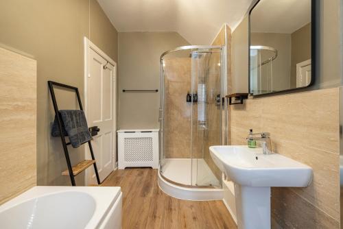 a bathroom with a shower and a sink and a mirror at Home in Kelso Scottish Borders in Kelso