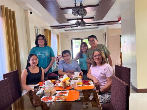 a group of people sitting around a table at Villa Cresenciana in Batuan