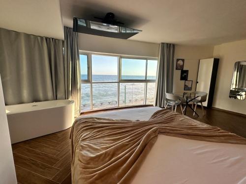 a bedroom with a bed with a view of the ocean at Villa Marbella by Potenza Rentals in Santo Domingo