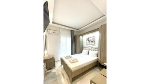 Ένα ή περισσότερα κρεβάτια σε δωμάτιο στο Myrto Rooms