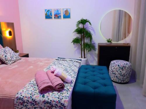 a bedroom with a bed with towels and a mirror at Appartement de Luxe MARTIL COSTA MAR Pour Familles in Martil