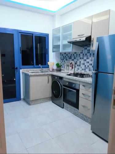 a kitchen with a refrigerator and a dishwasher at Appartement de Luxe MARTIL COSTA MAR Pour Familles in Martil