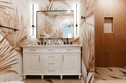 a bathroom with a white vanity and a large mirror at Tropical Disco 4 Bed Pool Home Near Beach in St Petersburg