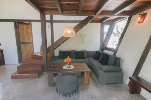 a living room with a couch and a table at Nahouse Jungle Lodges in Tulum