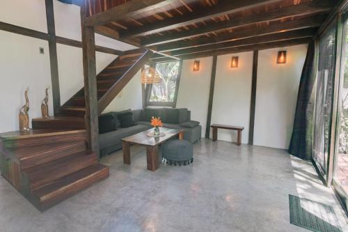 a living room with a couch and a table at Nahouse Jungle Lodges in Tulum