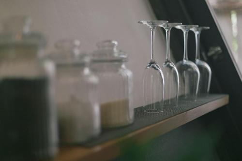 a row of glass bottles sitting on a shelf at Nahouse Jungle Lodges in Tulum