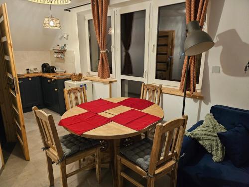 eine Küche mit einem Tisch und Stühlen in der Unterkunft Willa Szewcula Apartament Klimczok in Szczyrk