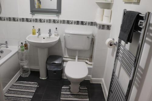 a small bathroom with a toilet and a sink at Dove's Place in historic Rochester with Parking in Strood