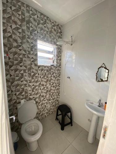a bathroom with a toilet and a sink at Xixová Hostel in São Vicente