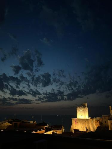 a building is lit up at night in a city at Ruffini Rooms in Termoli