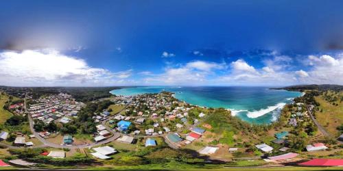 an aerial view of a town next to the ocean at Fish Tobago Guesthouse or Joy and Brandon Guesthouse in Buccoo