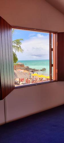 ventana con vistas a la playa y al océano en Beira mar maragogi, en Maragogi