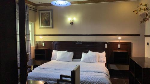 Un ou plusieurs lits dans un hébergement de l'établissement NBS Hotel & Suite