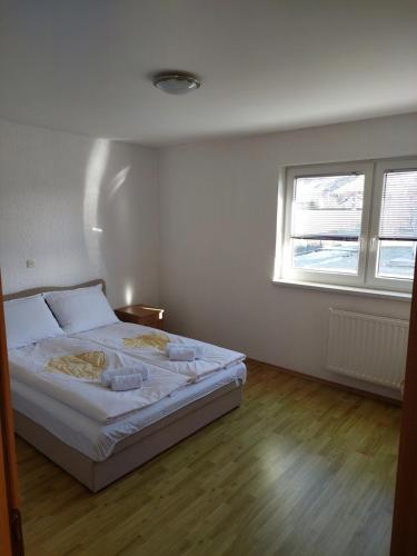 a bedroom with a bed in a room with a window at Kuća Vesna in Kupres