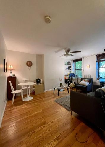 a living room with a couch and a table at Lovely Full Apartment x East Village (Thompkins Square Park) in New York