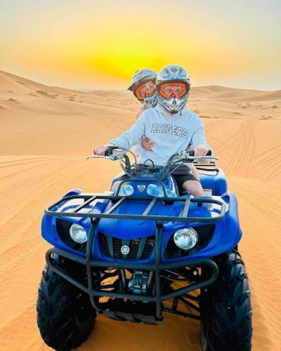 a person riding a quad bike in the desert at Dar Hassi Labied Merzouga in Hassilabied