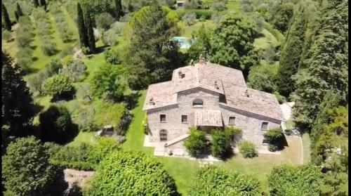 an aerial view of a large stone house with trees at Magnolia House in Cetona