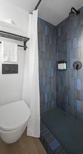a bathroom with a toilet and a shower at Riverside Tower Hotel in New York
