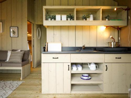 a kitchen with a sink and a counter top at De Limes Hoeve Safaritent A1 in Ingen
