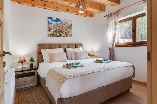 a bedroom with a large bed and a window at SOKOL - Falcon's nest villa in Gračac