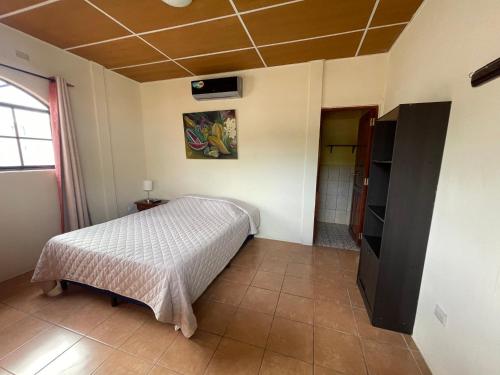 a bedroom with a bed in a room at Hotel Vizcaino in Matagalpa