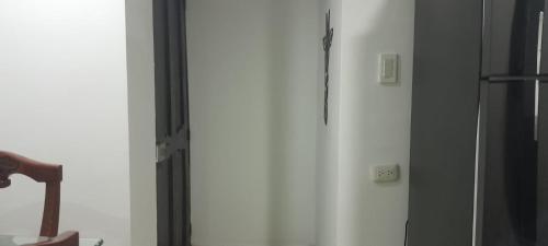 a white wall with an electrical outlet on it at El Encanto III - ApartaSuite in Barranquilla