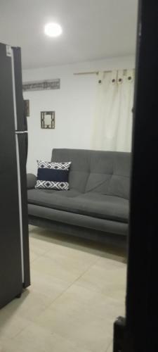 a living room with a couch in a room at El Encanto III - ApartaSuite in Barranquilla