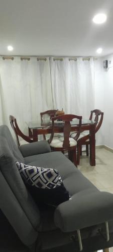 a living room with two tables and a couch at El Encanto III - ApartaSuite in Barranquilla