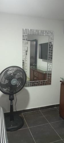 a mirror with a table in front of a room at El Encanto III - ApartaSuite in Barranquilla