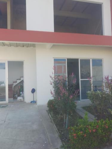 a white building with windows and plants in front of it at casa alvis H7 ,condominio in La Colorada