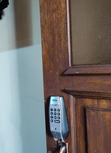 a remote control is attached to a wooden door at Habitacion 2 camas in Oruro