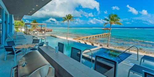 a resort with a swimming pool and a beach at Evolution villa in Bodden Town