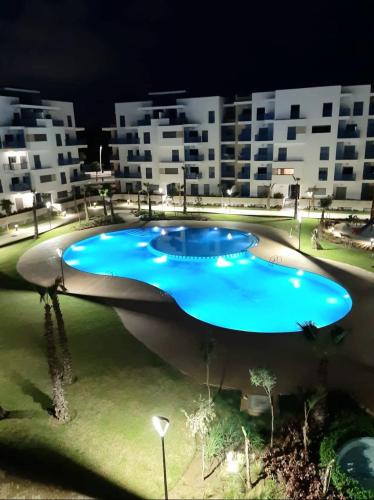 a large swimming pool in front of some buildings at Appartement de Luxe MARTIL COSTA MAR Pour Familles in Martil