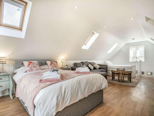 a bedroom with a large bed and a couch at 2 bed property in Bradford-on-Avon 87056 in Southwick