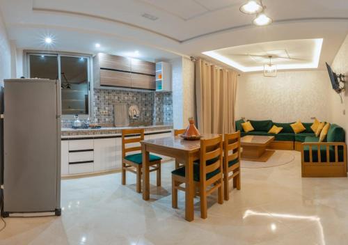 a kitchen and living room with a table and chairs at Malak House in Imsouane