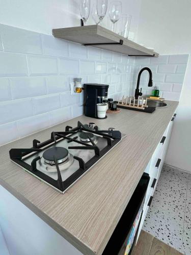 a kitchen counter with a stove top in a kitchen at Villa Marbella by Potenza Rentals in Santo Domingo